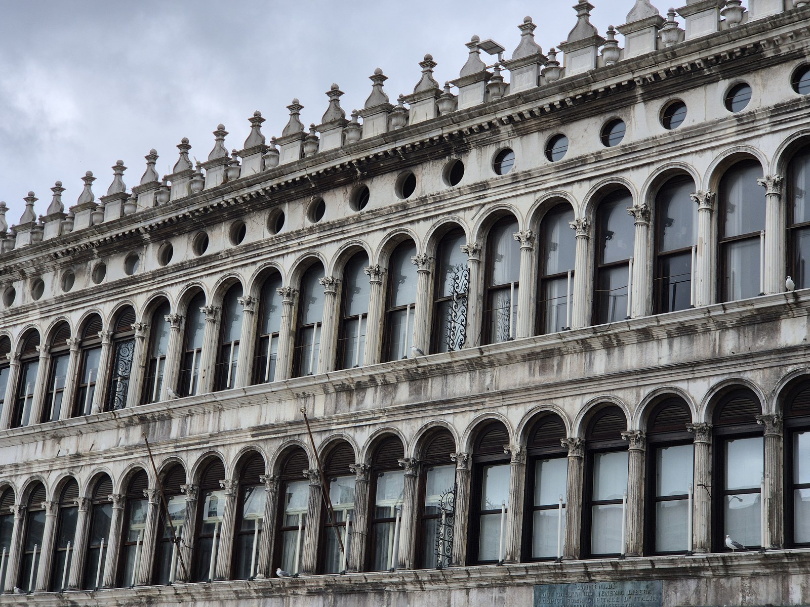 Rows of arched windows on an ornate stone facade
