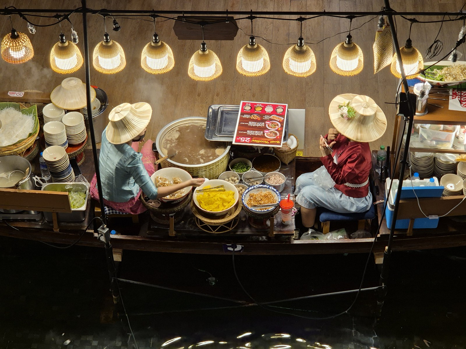 Warmly lit food stall viewed from above