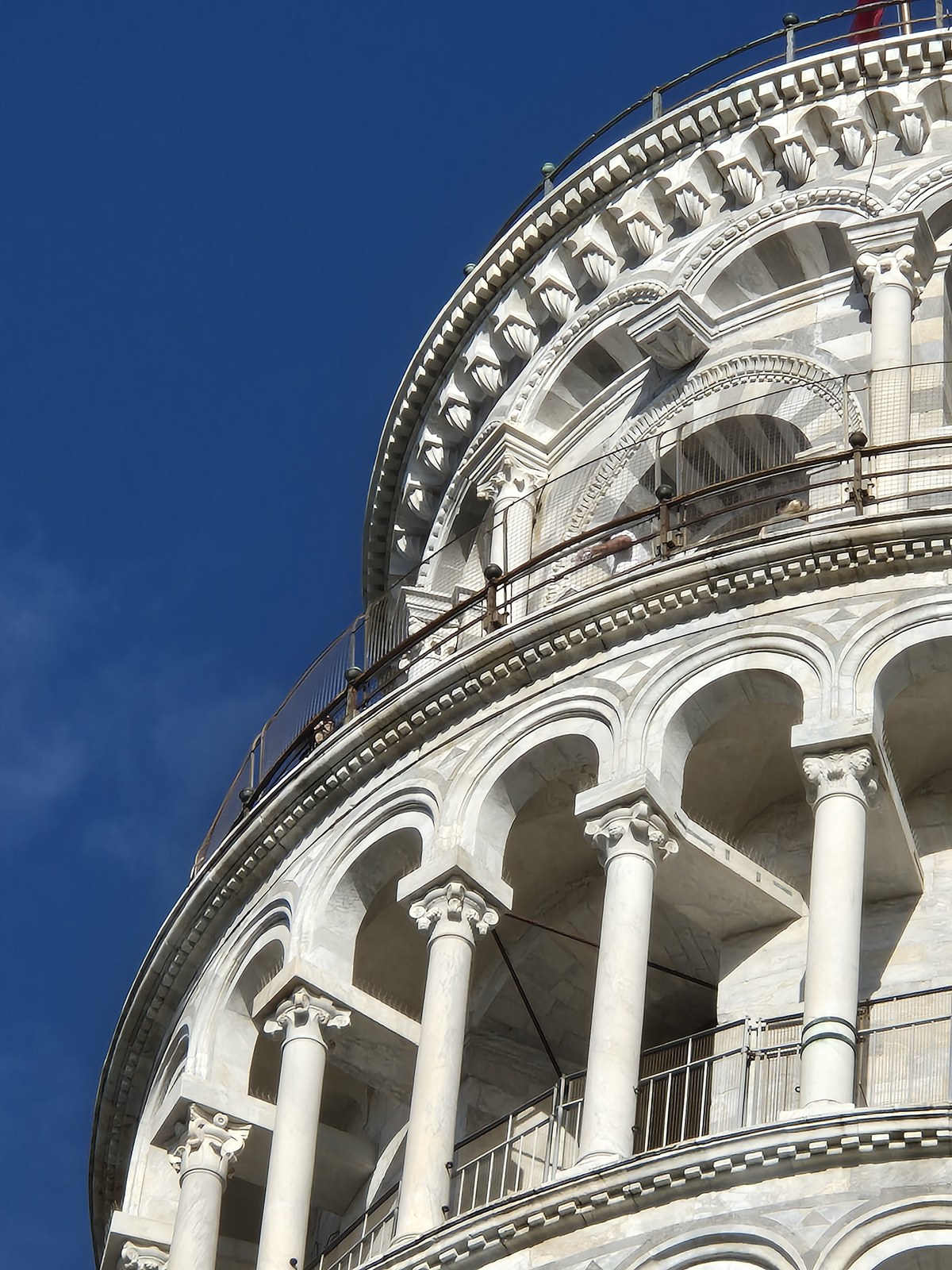 Curving rows of arches on a white stone tower