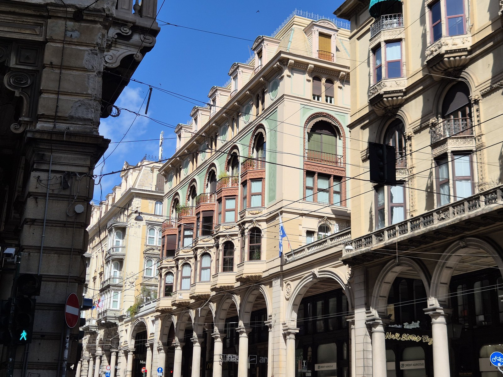 Historic facades along a sunlit street