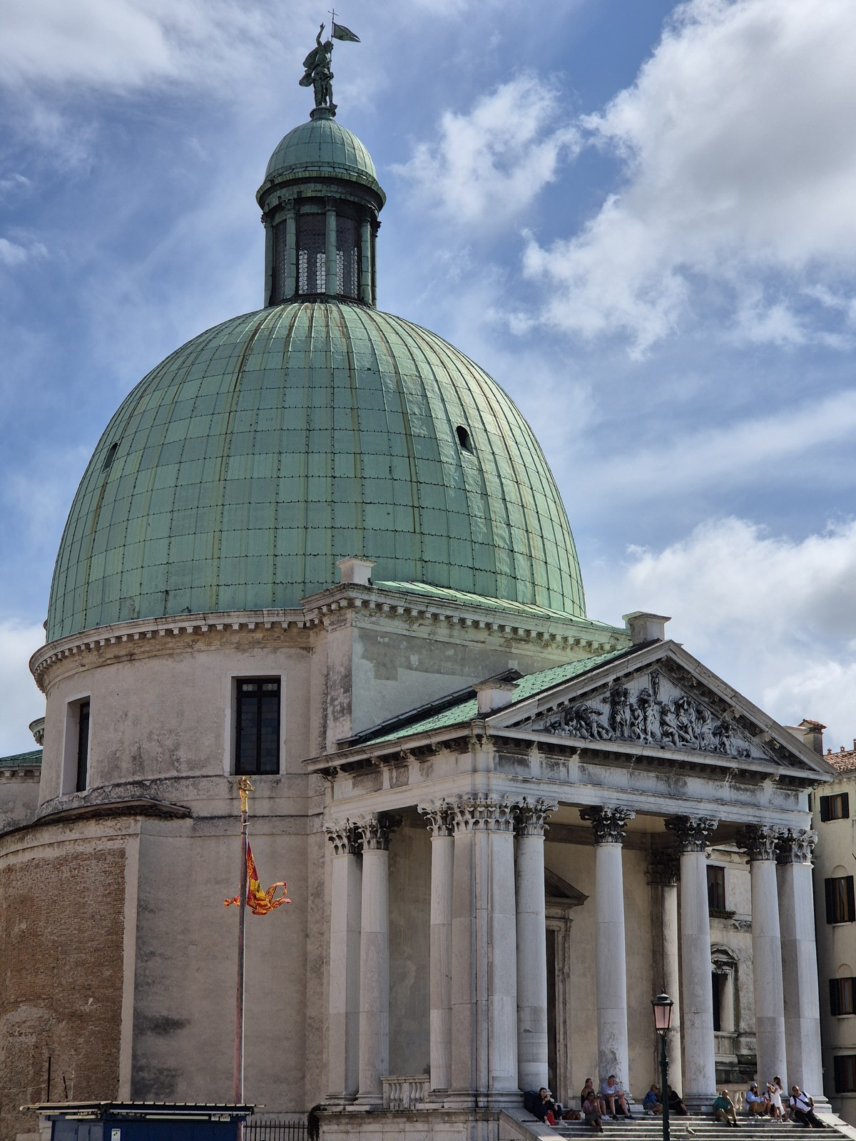Green dome above a classical stone facade