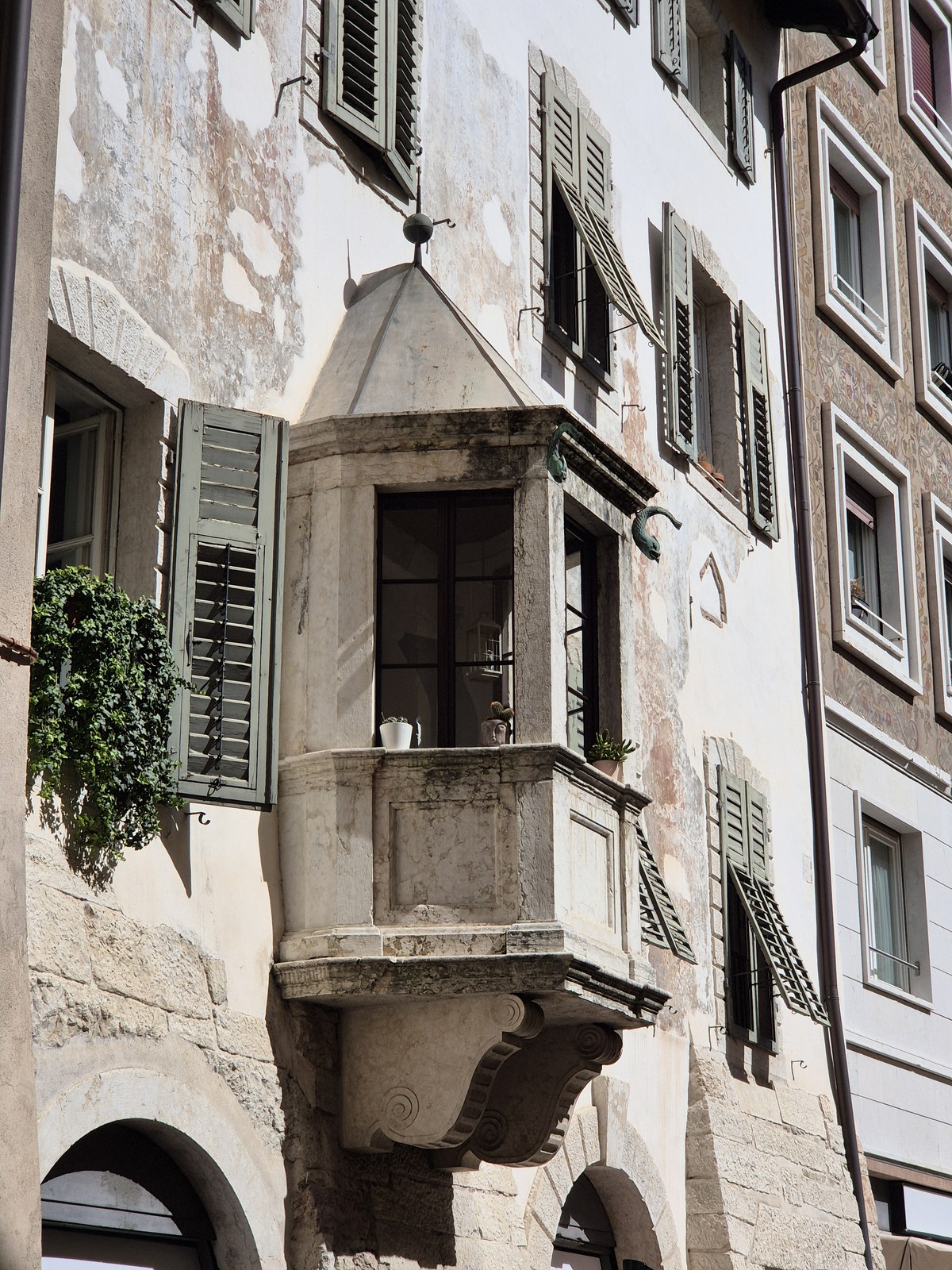 Shuttered windows and a small stone balcony