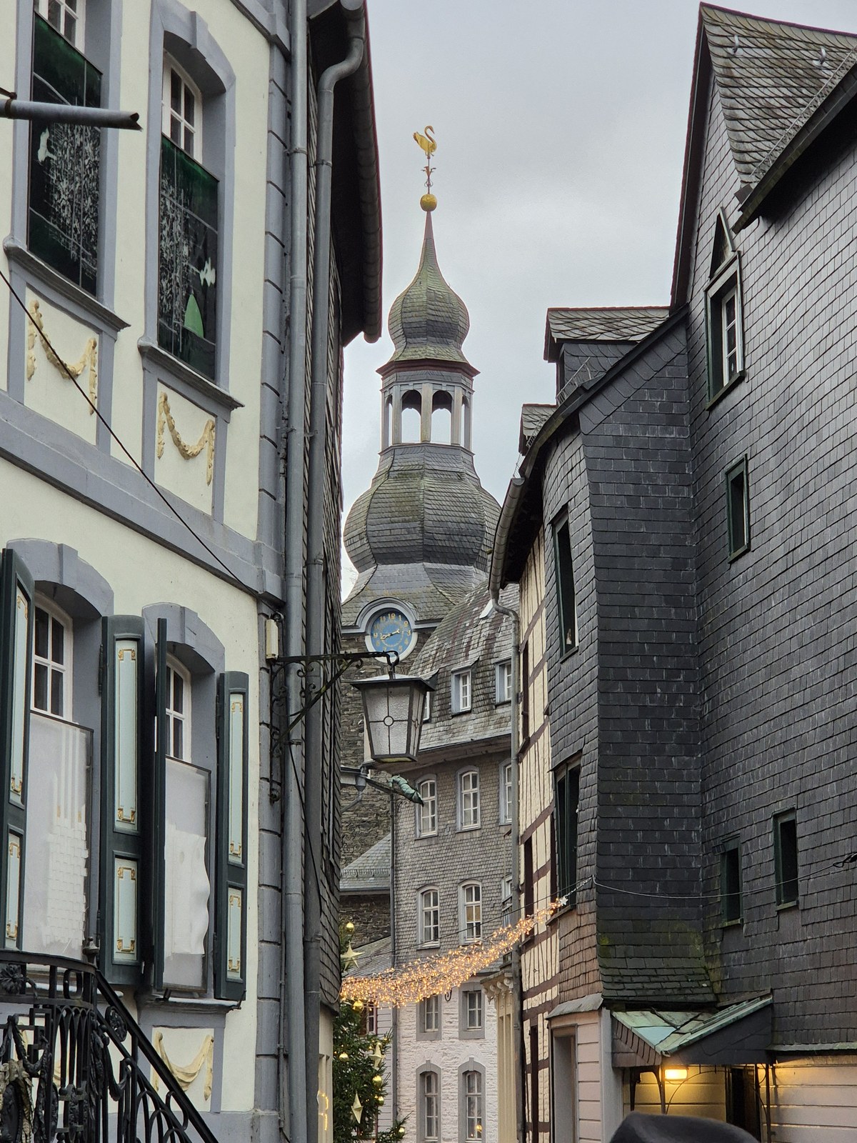 View along a narrow street towards a tower