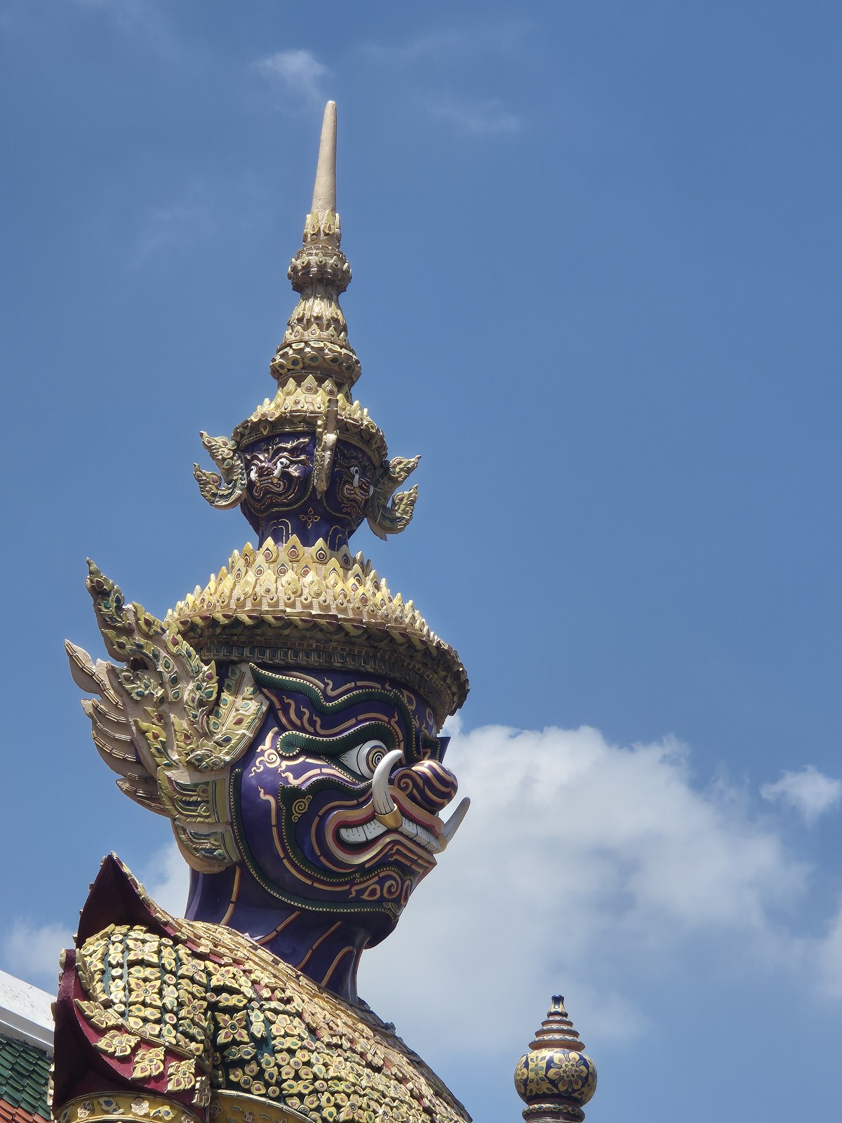 Ornate guardian statue with a tall gold headdress