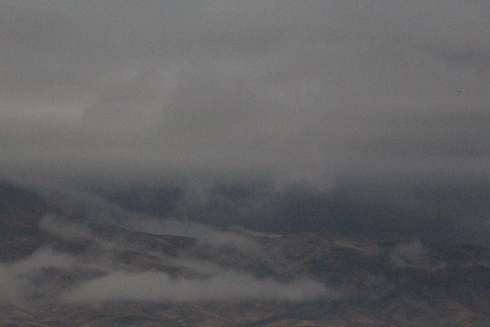 Low clouds over a distant mountain landscape